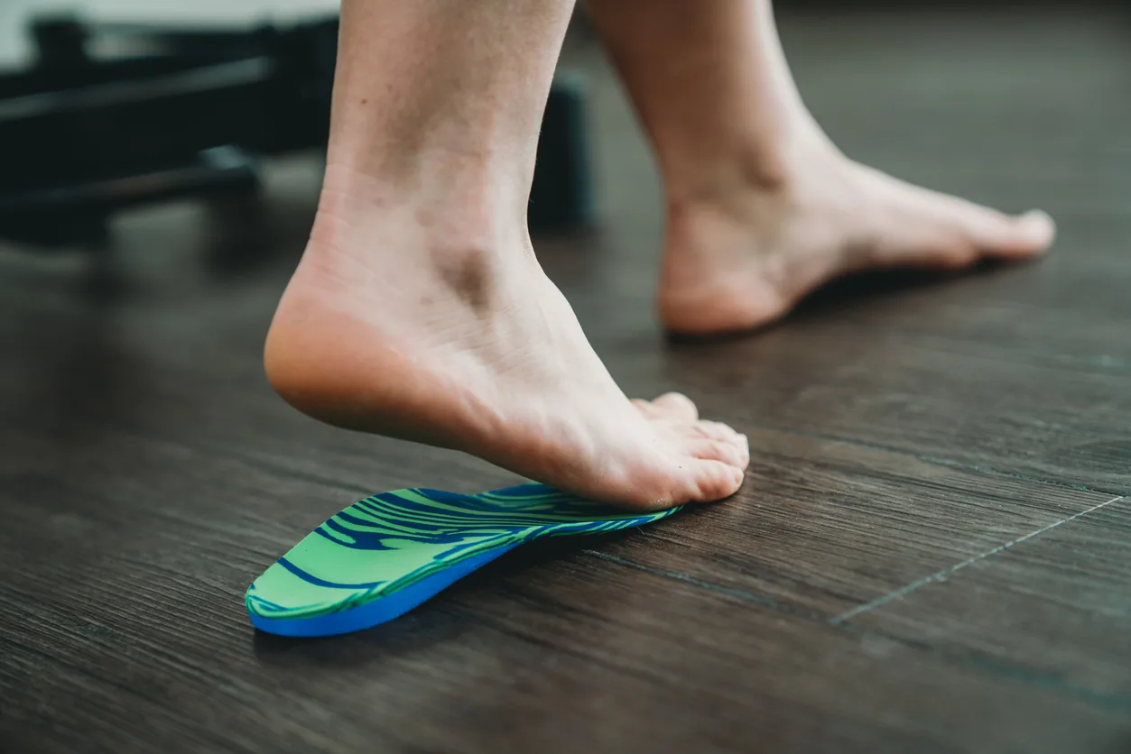 A podiatrist treating an athlete's foot and ankle in the Bexley clinic
