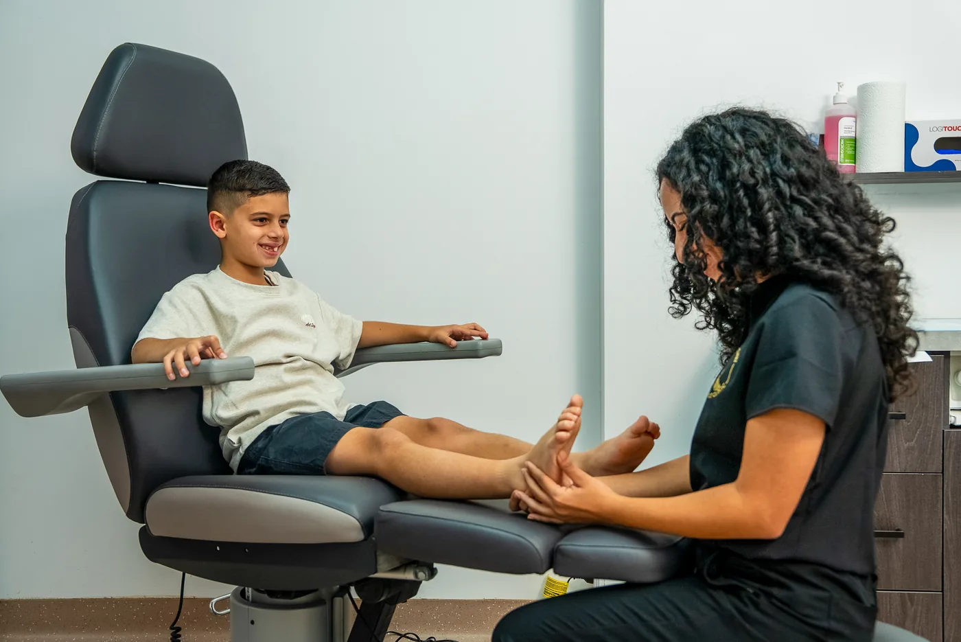 A podiatrist assessing a child's foot at Bexley Podiatry: Foot & Ankle Clinic