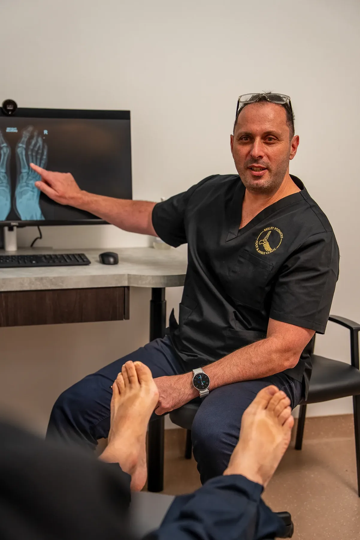 A podiatrist examining a patient's foot and ankle at Bexley Podiatry: Foot & Ankle Clinic