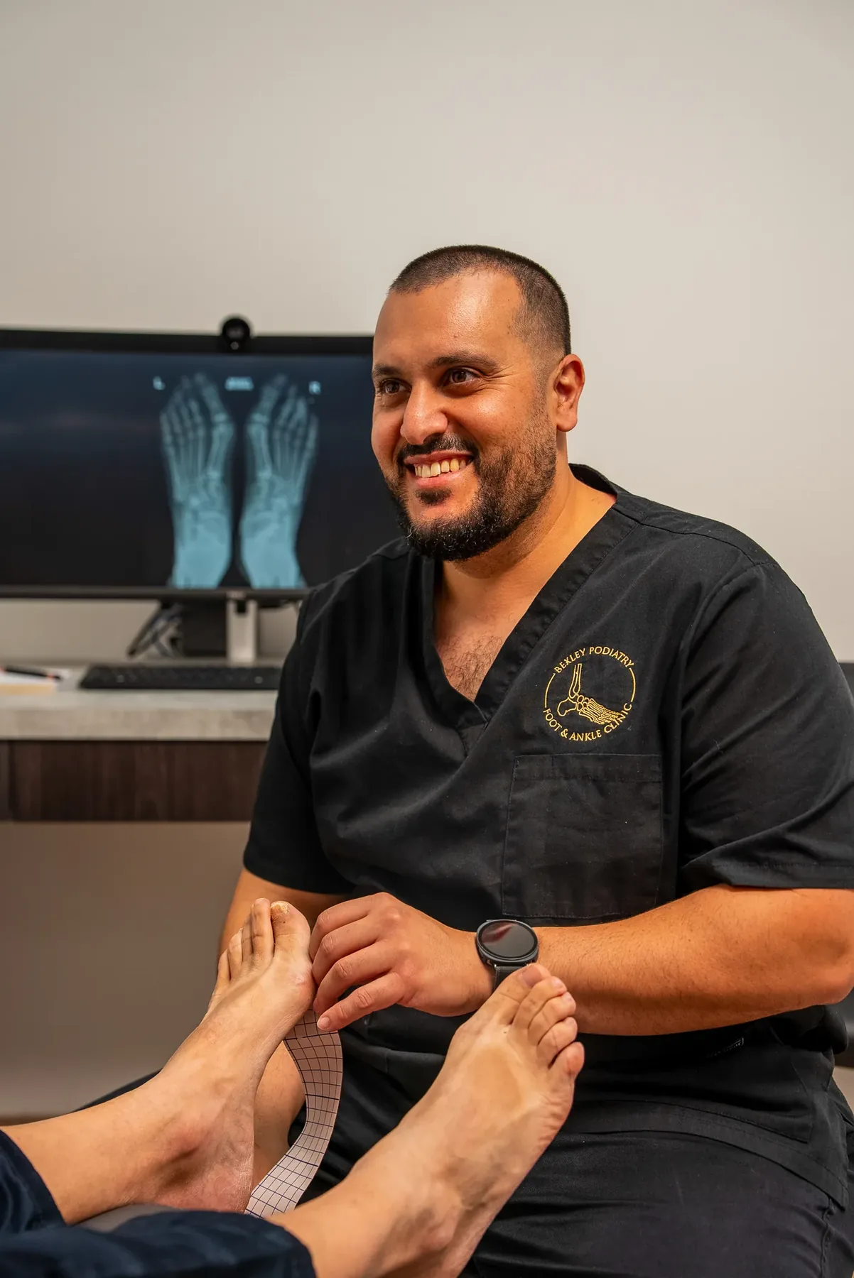 A podiatrist examining a patient's toes at Bexley Podiatry: Foot & Ankle Clinic