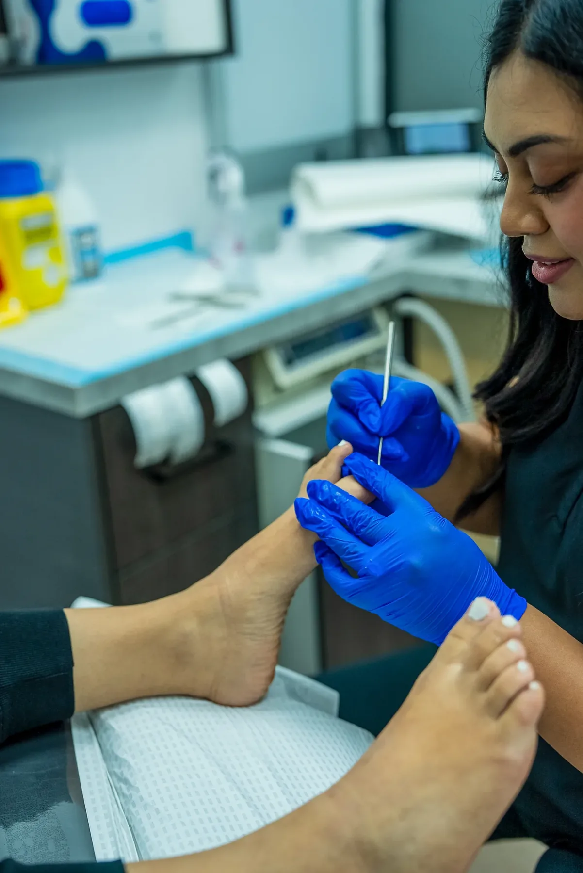 A podiatrist delivering an injection to a patient's foot at Bexley Podiatry: Foot & Ankle Clinic