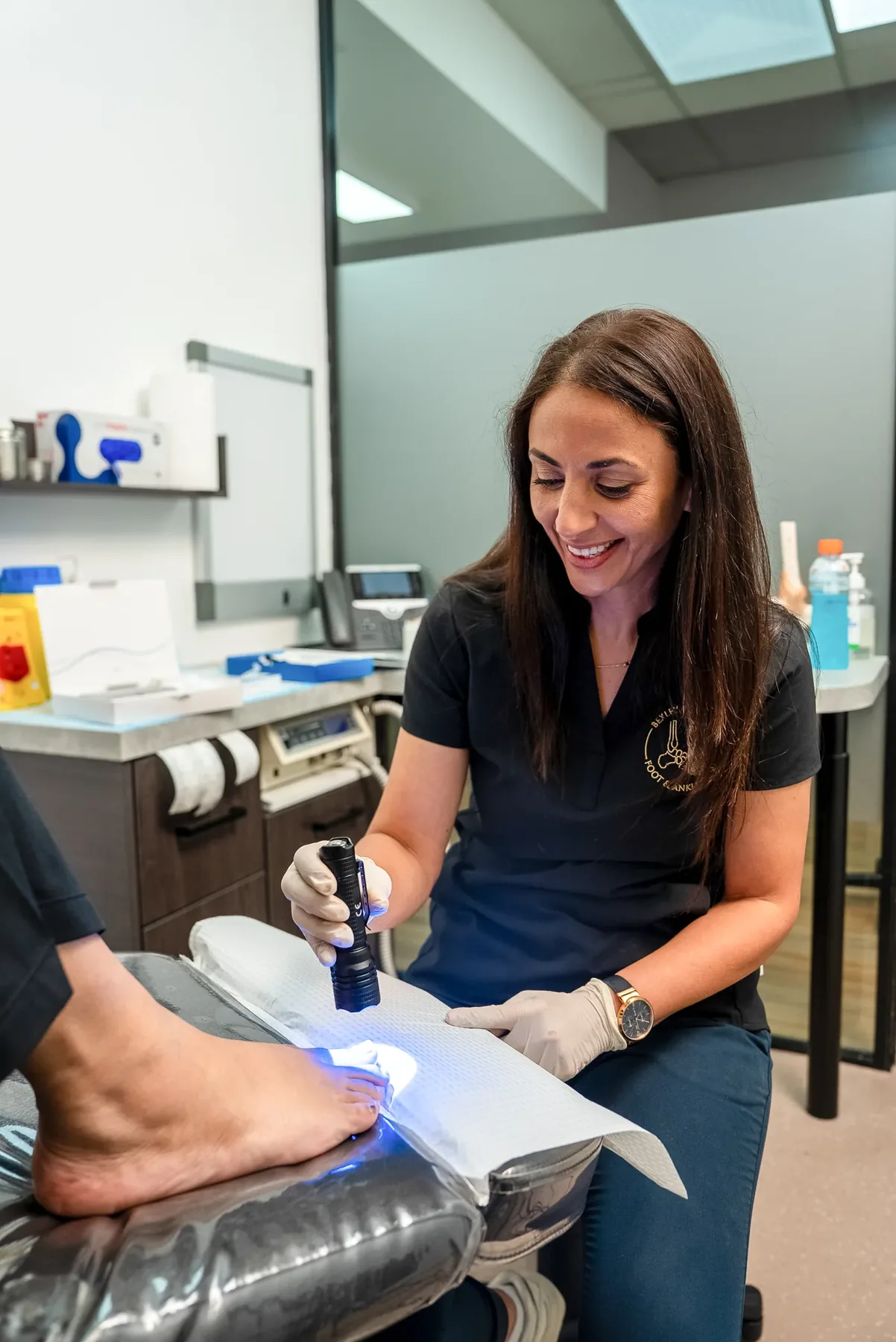 A podiatrist performing an in-clinic foot procedure at Bexley Podiatry: Foot & Ankle Clinic